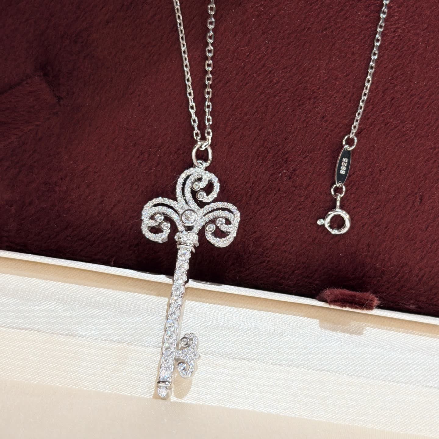 Tiffany & Co Elegant Silver Key Pendant with Diamonds
